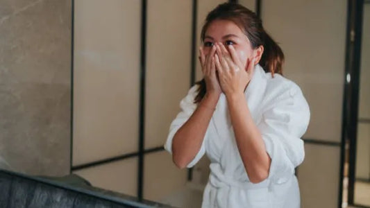 Woman gently washing face after microneedling session