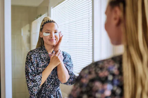 woman applying anti-aging eye patches for fine lines under eyes