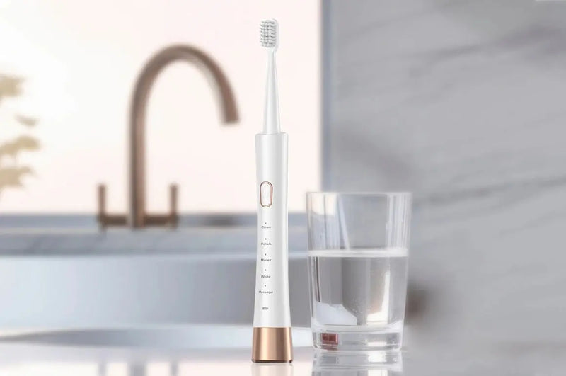ultrasonic-toothbrush-next-to-cup-of-water
